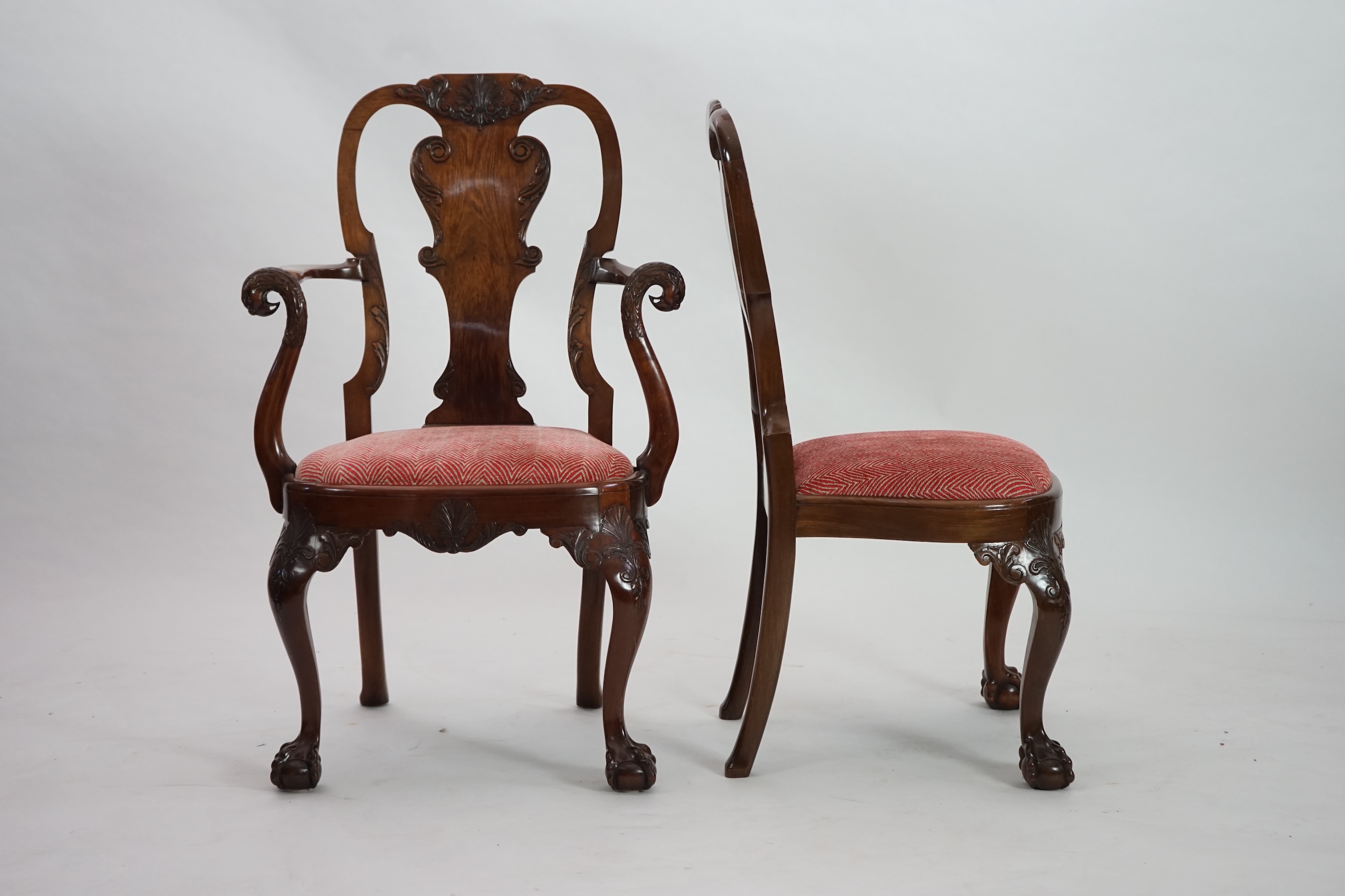 A set of twelve Queen Anne revival walnut dining chairs, including two carvers